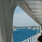 Passengers enjoy a ferry ride with views of the Bosphorus Bridge in Istanbul.