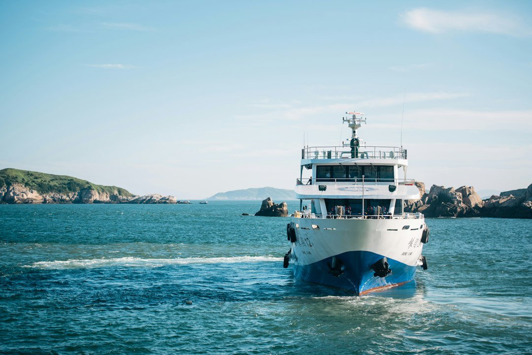 white-and-blue-cruise-ship-on-body-of-water-during-daytime-vt7z34h8lfo